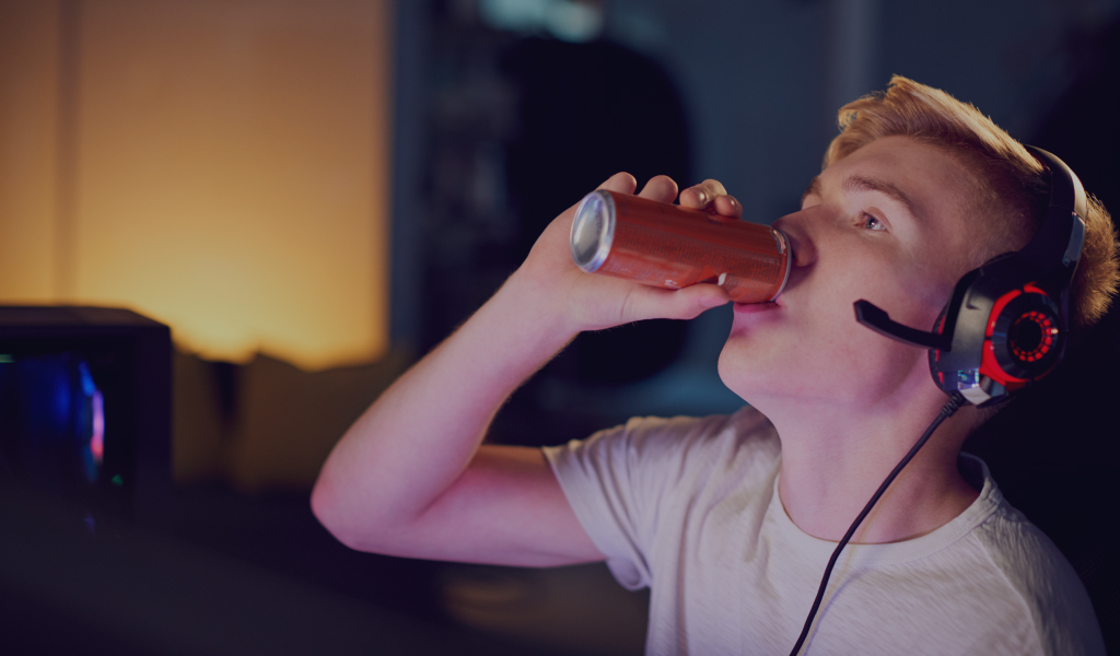 teenage-boy-drinking-caffeine-energy-drink-gaming-YN93FWV.jpg